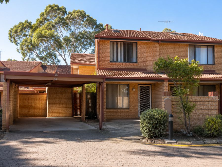 A brick strata townhouse with a carport