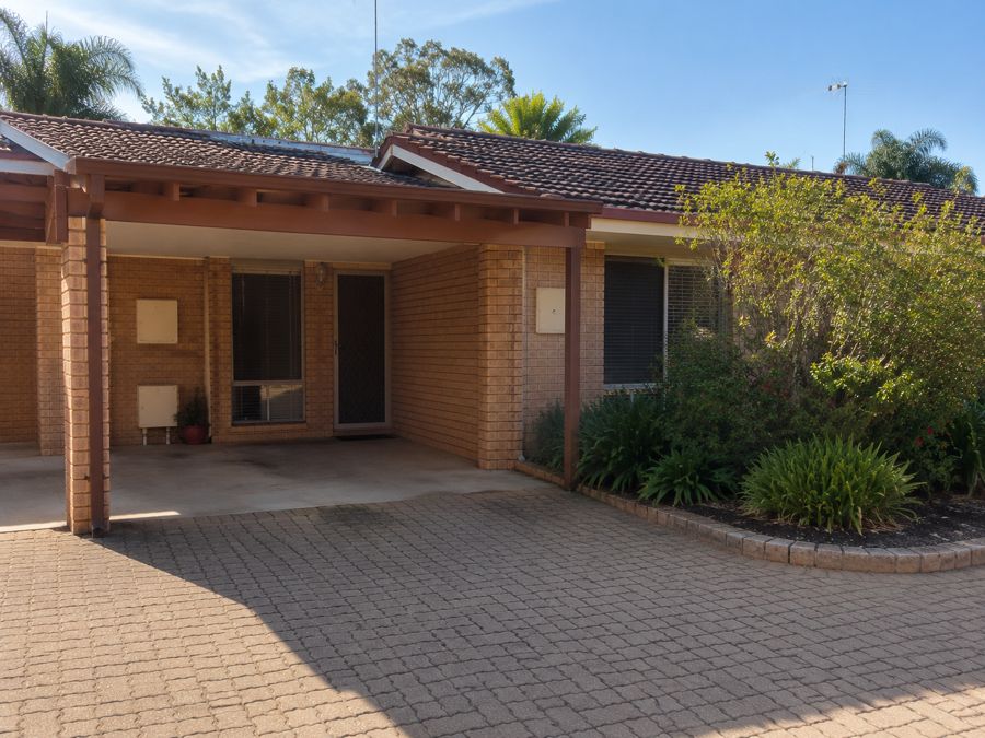 A single storey brick villa with a carport